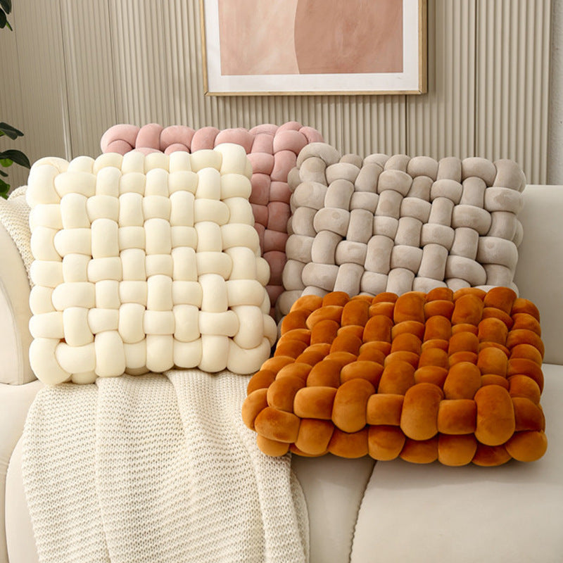 Square woven plush seat cushions in cream, pink, beige, and orange, perfect for sofas and decorative use.