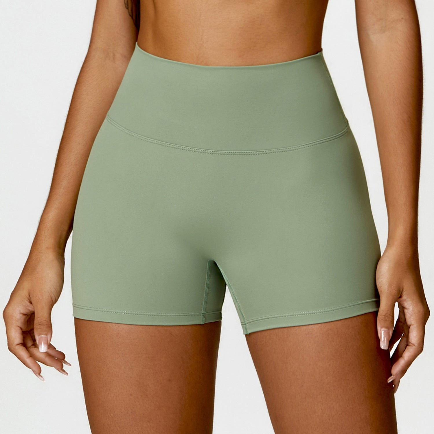 High-Waisted Tummy Control Yoga Shorts in peach, designed for fitness with a lift-booty feature and a sleek, flattering fit.