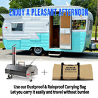 Portable 12" Wood-Fired Outdoor Pizza Oven with Rotating Turntable, shown with a carrying bag, set against a vintage trailer 