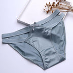 Satin Milk Silk girl underwear in light blue, featuring a hollow butterfly knot design and seamless, low-waist triangle cut.