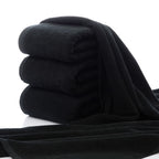 Luxury 100% Cotton Black Terry Bath & Face Towels stacked neatly, showcasing their soft texture and rich color.