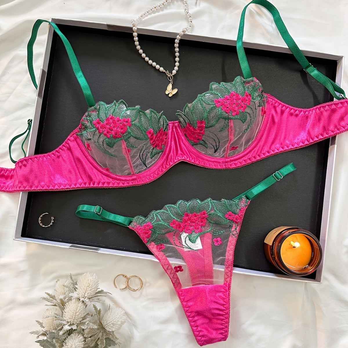 Close up of embroidered details on see-through black bra top.