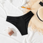 Solid Color Sexy Bikini – Pleated Low Waist Triangle Swimsuit in black, displayed with sunglasses and a straw hat on a white 