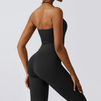 Black one-piece yoga suit for women featuring a strapless design and flare leggings, ideal for fitness and workouts.