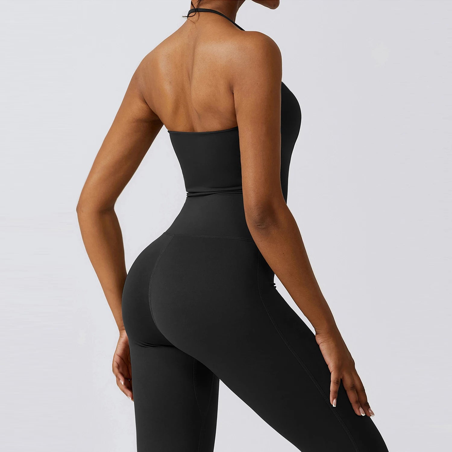 Black one-piece yoga suit for women featuring a strapless design and flare leggings, ideal for fitness and workouts.