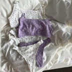 Knit Jacquard Camisole and Thong Two-Piece Set featuring a purple camisole and two patterned thongs on a soft, textured backg