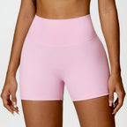 High-waisted peach yoga shorts designed for tummy control and a flattering fit, ideal for fitness activities.