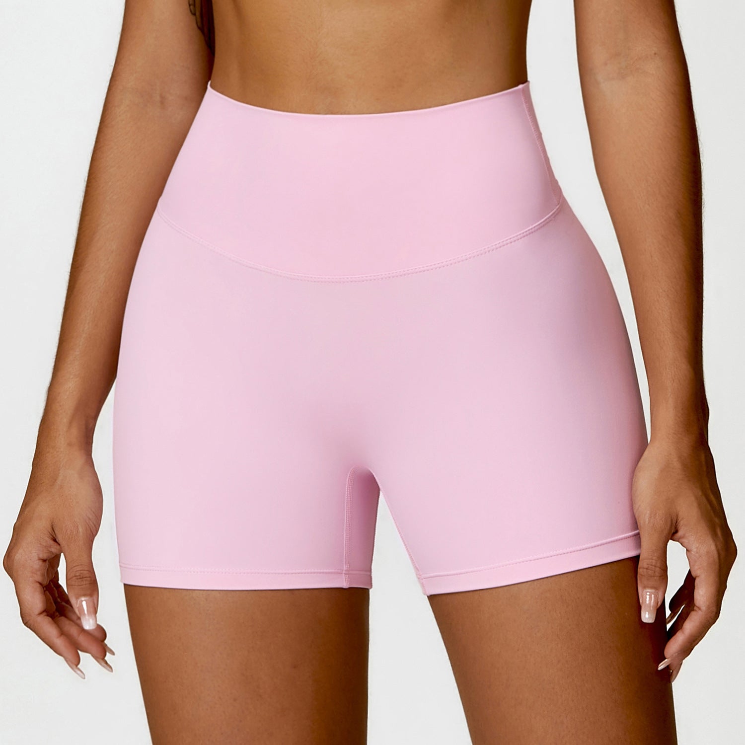 High-waisted peach yoga shorts designed for tummy control and a flattering fit, ideal for fitness activities.