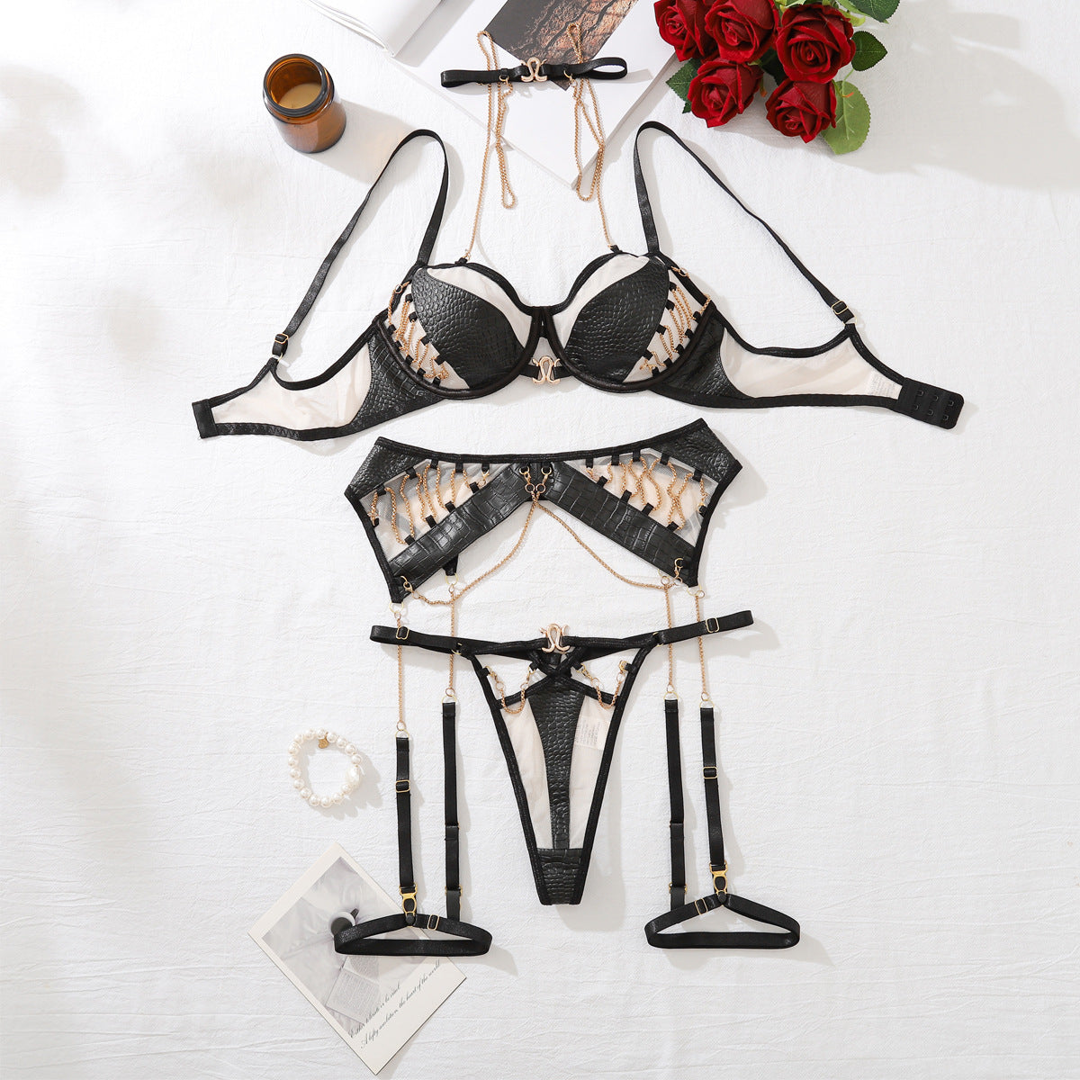 Women's Leather & Metal Chain Motorcycle Inspired Bra Set featuring a black leather bra and matching thong with gold accents.