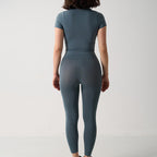 Seamless 2-Piece Activewear Set featuring a short sleeve sport t-shirt and long leggings in a muted blue color.