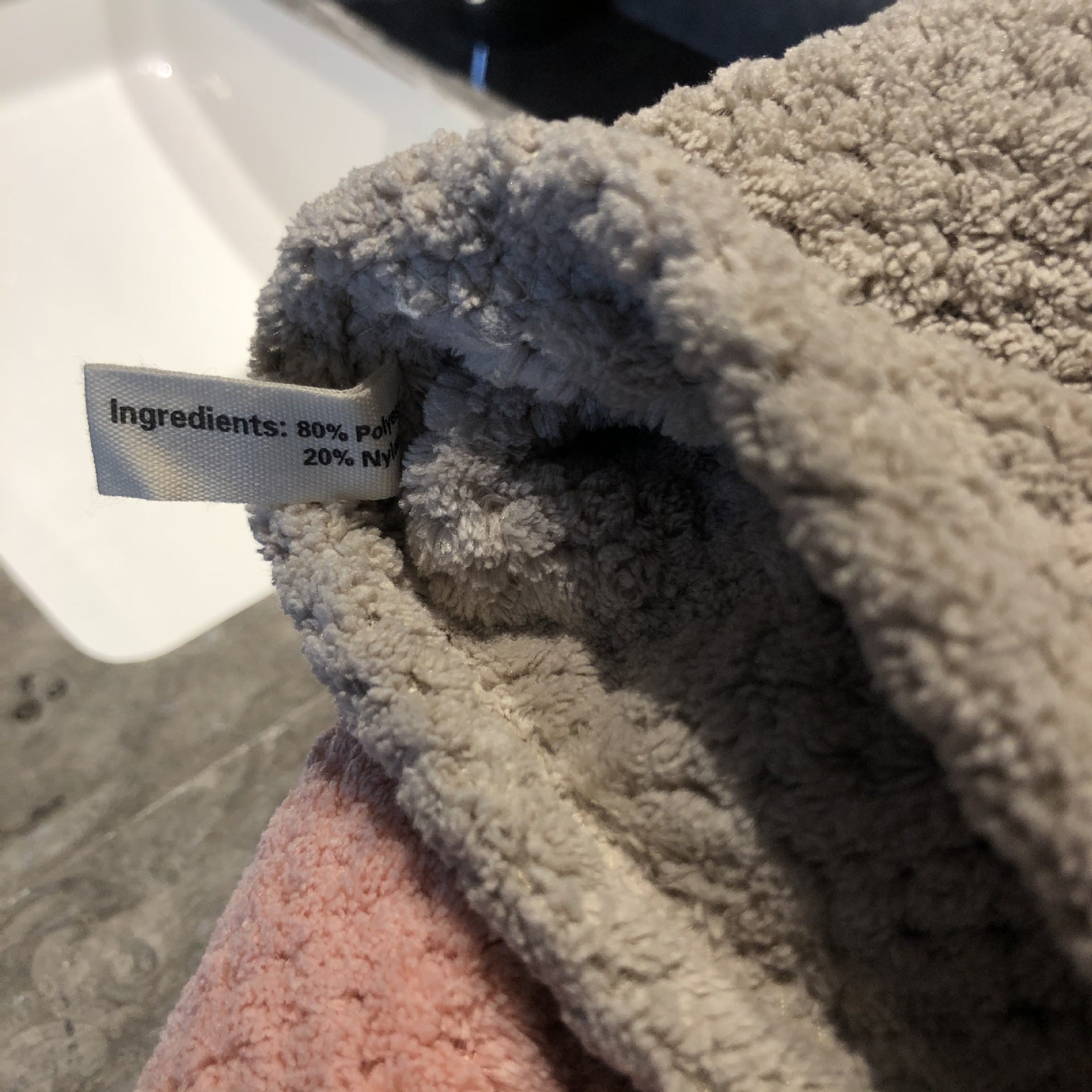 Ultra-Absorbent Coral Fleece Bath & Hand Towel Set in Pineapple Grid Collection, showcasing soft texture and care label.
