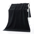 Luxury 100% Cotton Black Terry Bath & Face Towels displayed on a white towel rack, showcasing their soft texture and elegant 