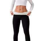 Women’s High-Waisted Sherpa Fleece-Lined Winter Leggings in black, showcasing a model pulling down the fleece-lined waistband