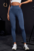 Back view of women's blue fitness leggings showing fit and seam details.