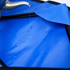 Heavy Duty Folding Utility Wagon with a blue interior, showing water being poured into the cart's fabric.