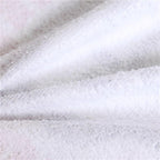 Close-up of soft, textured fabric of a Round Boho Beach Towel by classyfashionz, featuring a white surface.