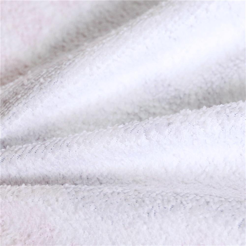 Close-up of soft, textured fabric of a Round Boho Beach Towel by classyfashionz, featuring a white surface.