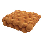 Square woven plush seat cushion in warm orange tones, ideal for sofas or bay windows, adding a decorative touch.