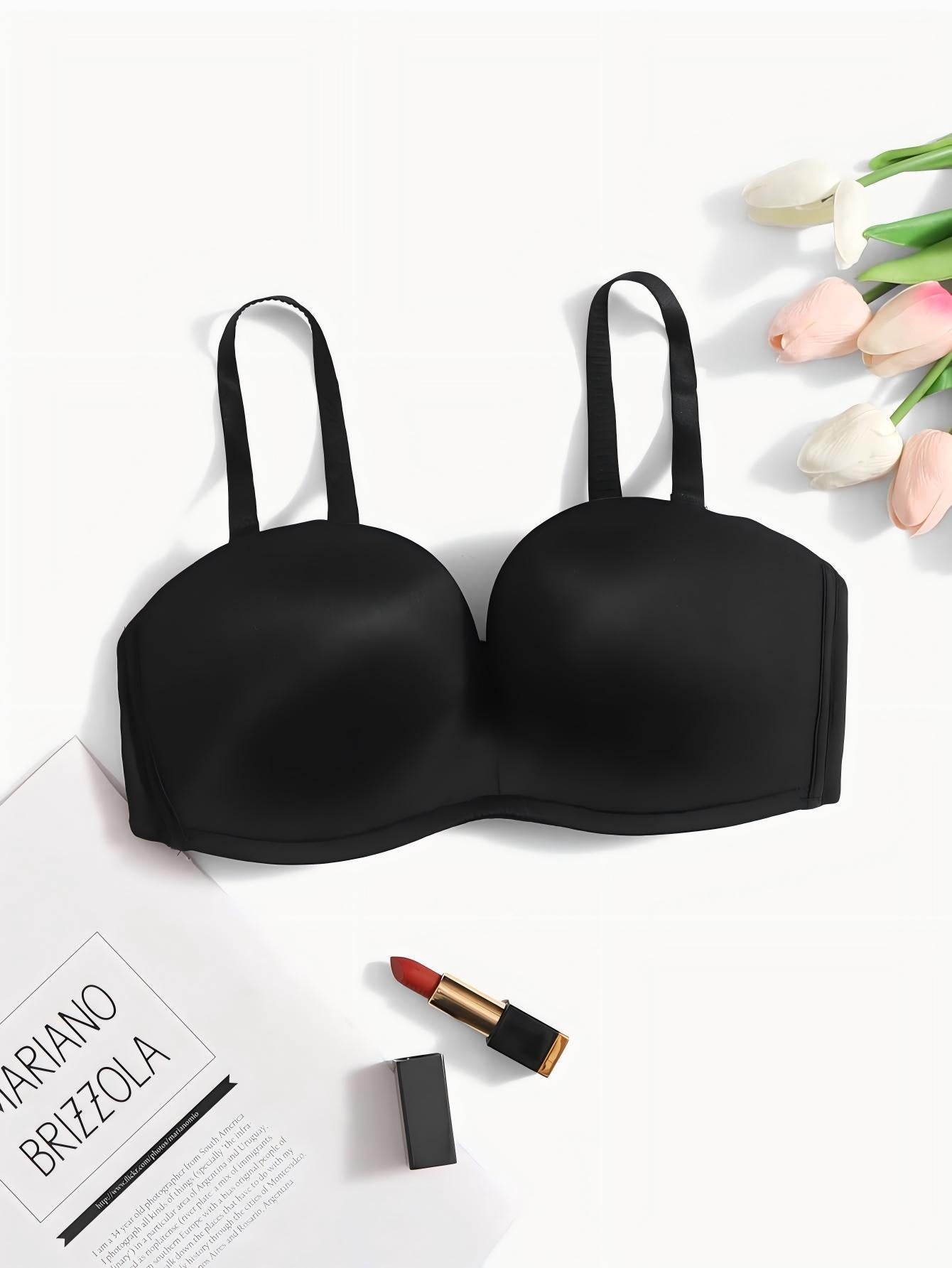 Black Women's Seamless Anti-Slip Gathered Comfort Bra with adjustable straps, displayed with tulips, lipstick, and magazine.