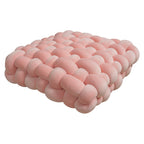 Square pink woven plush cushion with a soft, textured design, ideal for sofas or bay windows as a decorative pad.