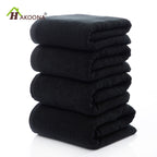 Luxury 100% Cotton Black Terry Bath & Face Towels stacked neatly, showcasing a soft, plush texture. Ideal for elegant bathroo