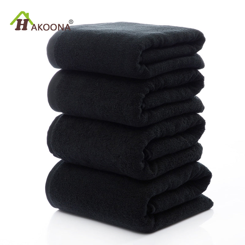 Luxury 100% Cotton Black Terry Bath & Face Towels stacked neatly, showcasing a soft, plush texture. Ideal for elegant bathroo