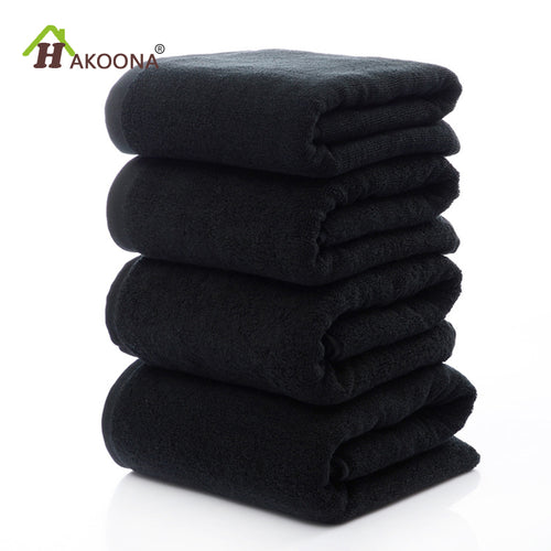 Luxury 100% Cotton Black Terry Bath & Face Towels stacked neatly, showcasing a soft, plush texture. Ideal for elegant bathroo