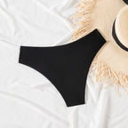 Solid Color Sexy Bikini – Pleated Low Waist Triangle Swimsuit in black, displayed on a white fabric with a straw hat.