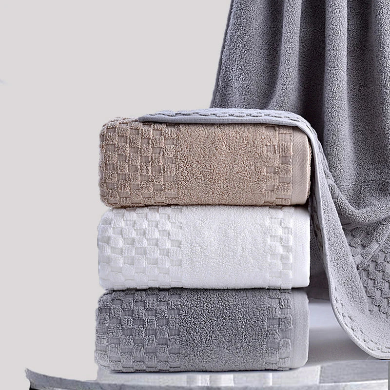 Premium Bamboo Charcoal Coral Velvet Bath Towel set in beige, white, and gray, showcasing ultra-absorbent texture.