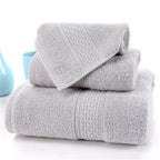 3-Piece Premium 100% Cotton Bath & Hand Towel Set in light gray, featuring textured patterns and soft, absorbent fabric.