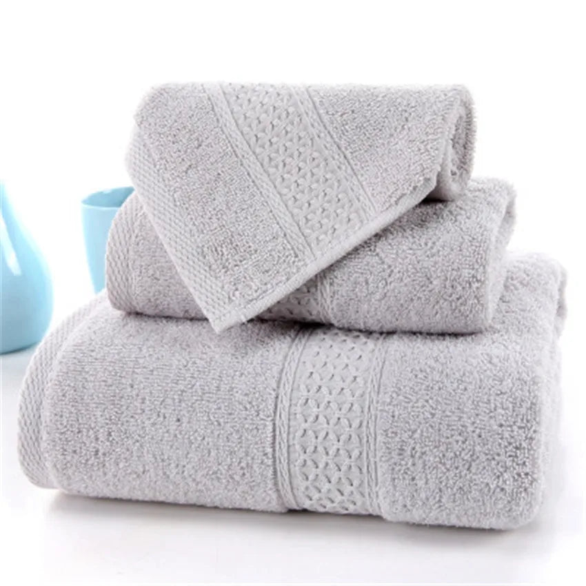 3-Piece Premium 100% Cotton Bath & Hand Towel Set in light gray, featuring textured patterns and soft, absorbent fabric.