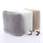 Premium Bamboo Charcoal Coral Velvet Bath Towels in gray, white, and beige, featuring a textured pattern and ultra-absorbent 