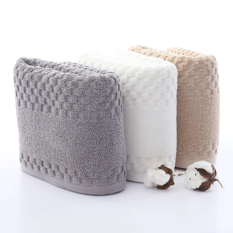 Premium Bamboo Charcoal Coral Velvet Bath Towels in gray, white, and beige, featuring a textured pattern and ultra-absorbent 