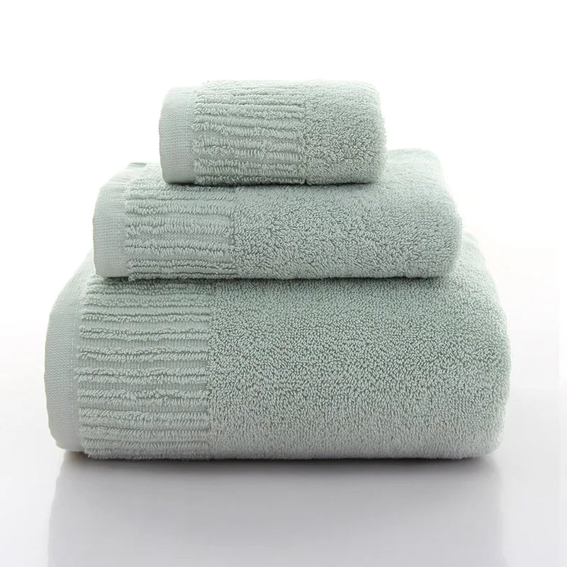Premium 100% Cotton Thickened Bath Towel Set in soft green, featuring three luxurious towels stacked neatly.