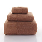 Premium 100% Cotton Thickened Bath Towel Set in a warm brown color, featuring three stacked towels of varying sizes.