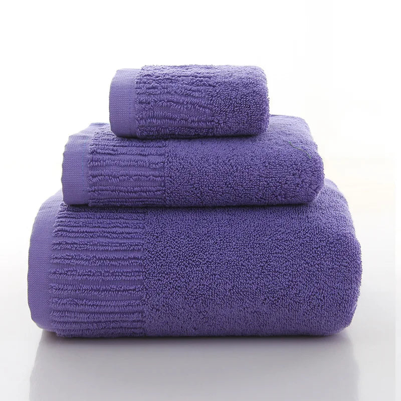 Premium 100% Cotton Thickened Bath Towel Set in purple, featuring three plush towels of varying sizes stacked neatly.