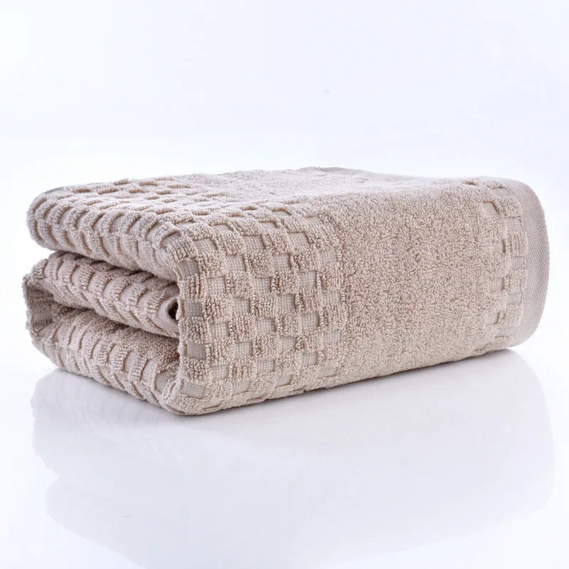 Premium Bamboo Charcoal Coral Velvet Bath Towel by classyfashionz, ultra-absorbent, folded with a textured pattern.