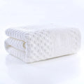 Premium Bamboo Charcoal Coral Velvet Bath Towel in white, ultra-absorbent, folded with textured pattern, part of spa collecti