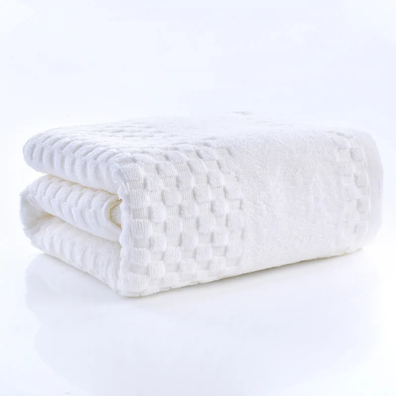 Premium Bamboo Charcoal Coral Velvet Bath Towel in white, ultra-absorbent, folded with textured pattern, part of spa collecti