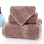 3-Piece Premium 100% Cotton Bath & Hand Towel Set in a soft brown color, featuring textured patterns and plush fabric.